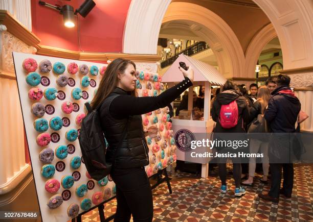 Woman takes a selfie in the QVB building during Vogue American Express Fashion's Night Out on September 6, 2018 in Sydney, Australia.