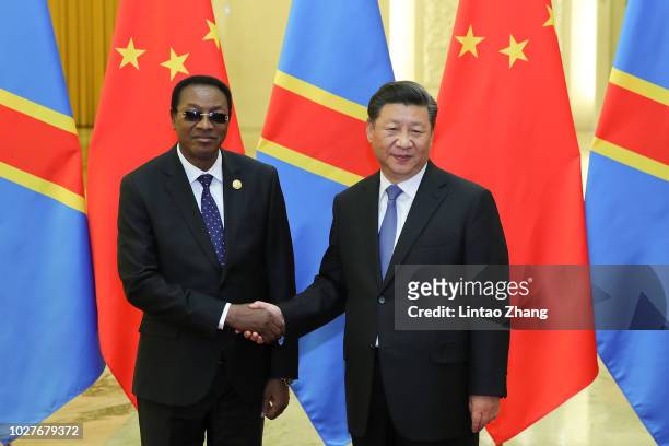 Chinese President Xi Jinping shakes hands with Bruno Tshibala Nzenze the Prime Minister of the Democratic Republic of the Congo before during a...