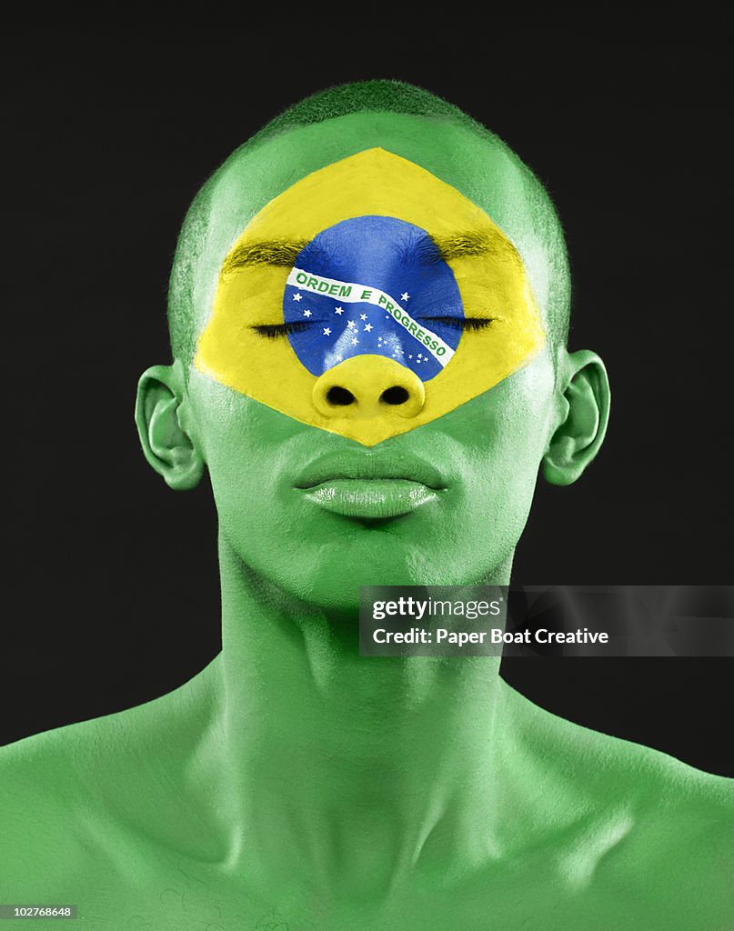 Brazilian flag painted on man's face