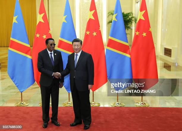 Chinese President Xi Jinping shakes hands with Prime Minister of the Democratic Republic of the Congo Bruno Tshibala Nzenze during a meeting at the...
