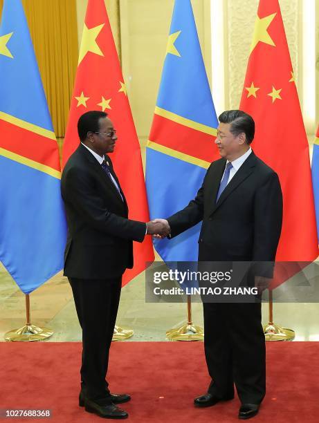 Chinese President Xi Jinping shakes hands with Prime Minister of the Democratic Republic of the Congo Bruno Tshibala Nzenze during a meeting at the...