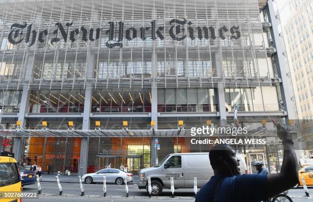 Man takes a selfie with his smartphone in front of the New York Times building on September 6, 2018 in New York. - A furious Donald Trump called...