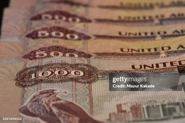 close up of united arab emirates currency notes - united arab emirates currency stock pictures, royalty-free photos & images