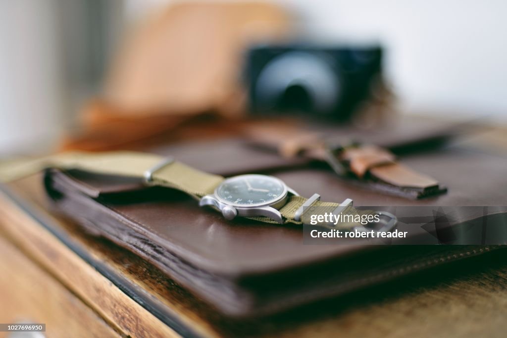 Military wristwatch on wooden cabinet