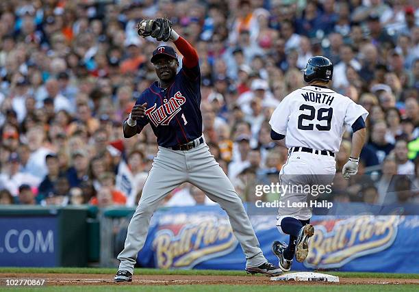 Danny Worth of the Detroit Tigers beats the throw to Orlando Hudson of the Minnesota Twins as he covers first base during the second inning of the...