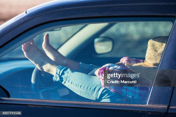 woman resting in a driver's seat - driving barefoot stock pictures, royalty-free photos & images