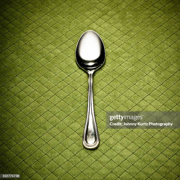 silver spoon on green diamond placemat - elegant spoon stock pictures, royalty-free photos & images