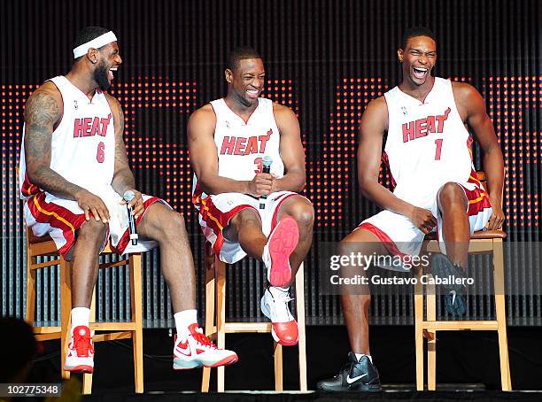LeBron James, Dwyane Wade and Chris Bosh of the Miami Heat speak after being introduced to fans during a welcome party at American Airlines Arena on...