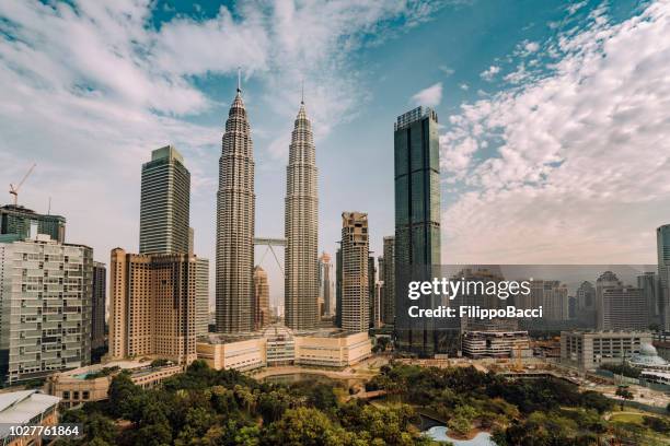 kuala lumpur skyline with petronas towers at sunset - malaysia skyline stock pictures, royalty-free photos & images