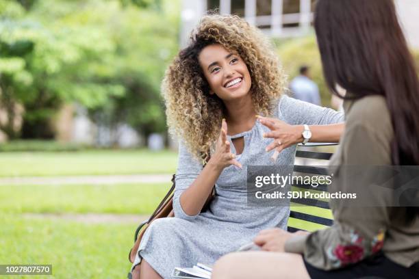 college student tells friend about her weekend - stories of the day stock pictures, royalty-free photos & images