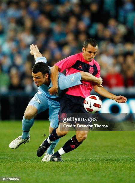 Mark Bridge of Sydney FC competes with Leon Osman of Everton during a pre-season friendly match between Sydney FC and Everton FC at ANZ Stadium on...