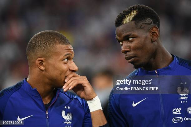 France's midfielder Kylian Mbappe and France's midfielder Paul Pogba talk during the national anthem before the UEFA Nations League football match...