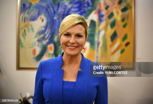 Croatian President Kolinda Grabar Kitarovic poses for pictures after a private meeting with Salvadoran AFP photographer Yuri Cortez's family at the...