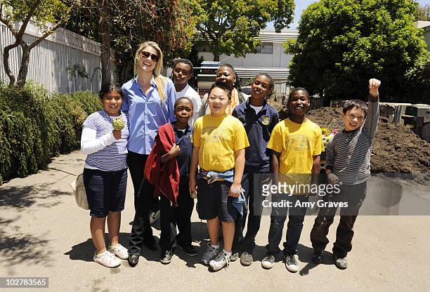 Ali Larter poses for a photo with children attending the Environmental Media Association and Yes to Carrots Garden Luncheon at The Learning Garden at...