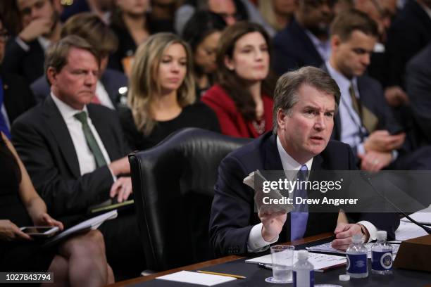 Supreme Court nominee Judge Brett Kavanaugh holds a copy of the Constitution as he testifies before the Senate Judiciary Committee on the third day...