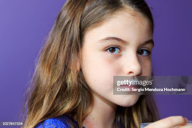 young girl looking at the camera with a milk mustache - milk moustache stock-fotos und bilder