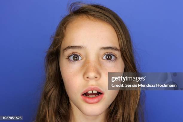 young girl looking at the camera surprised - child shock studio stock pictures, royalty-free photos & images