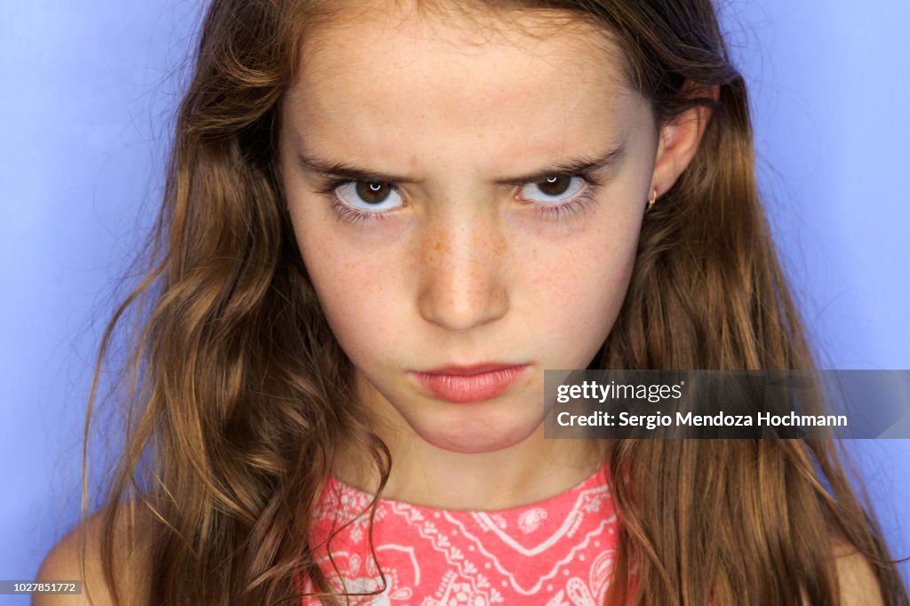 Young girl looking at the camera angry