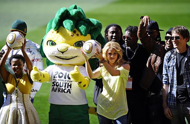 Colombian singer Shakira , flanked by Zakumi the official tournament mascot and local artists, holds the Jo'bulani football that will be used for the...