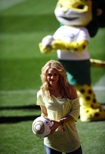 Colombia's singer Shakira, holding the Jo'bulani football that will be used for the final of the tournament, stands next the official mascot Zakumi...