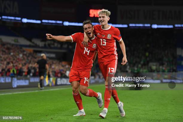 Connor Roberts of Wales celebrates with teammate David Brooks after scoring his team's fourth goal during the UEFA Nations League B group four match...