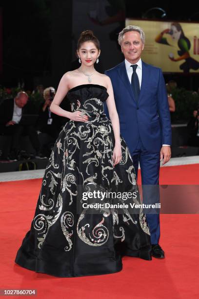 Guan Xiaotong and Jerome Favier walk the red carpet ahead of the Ying And 2018 Jaeger-LeCoultre Glory To The Filmaker Award to Zhang Yimou during the...