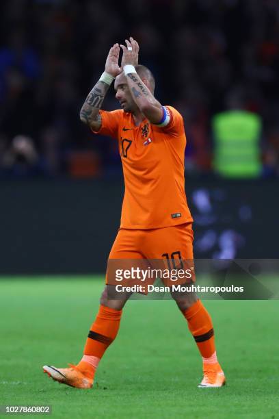 Wesley Sneijder of the Netherlands acknowledges the fans as he walks off after playing his last ever game for The Netherlands during the...
