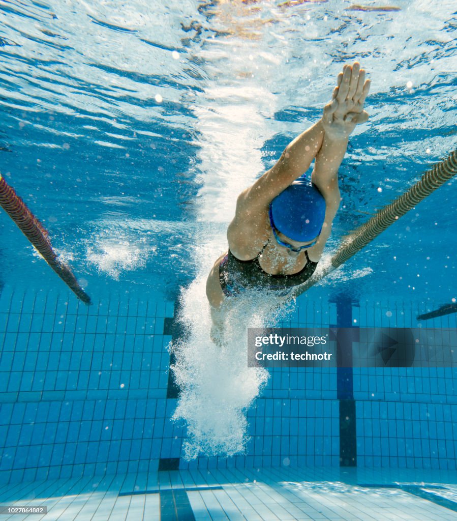 Underwater Shot of Young Women Diving into Water and Starting the Race