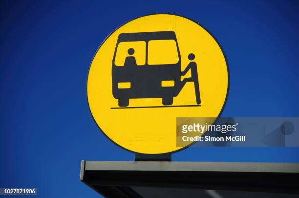 bus stop sign on a bus shelter - bus shelter foto e immagini stock