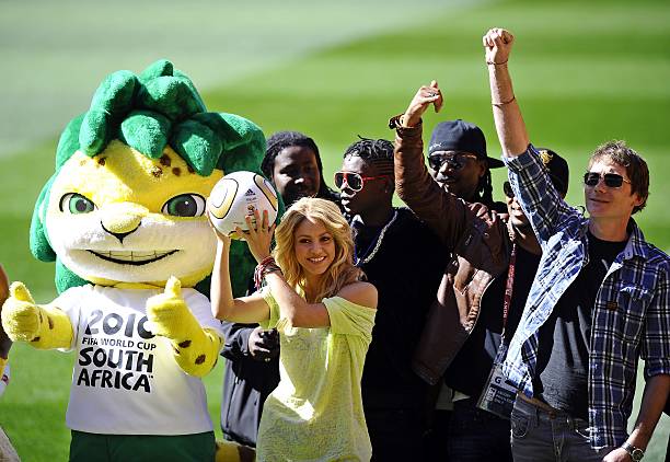 Colombian singer Shakira , flanked by Zakumi the official tournament mascot and local artists, holds the Jo'bulani football that will be used for the...