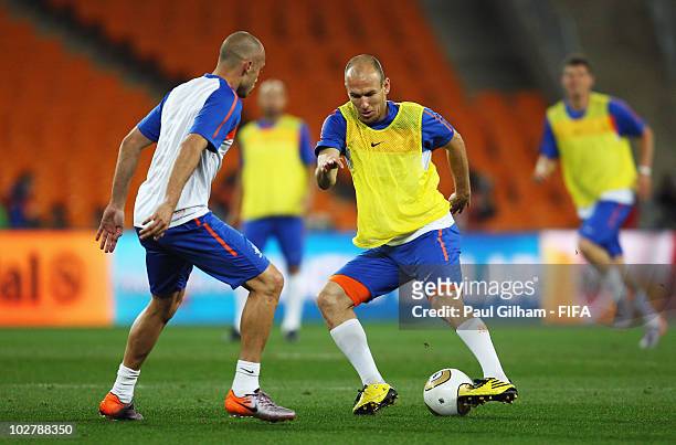 Arjen Robben of the Netherlands takes on team mate Johnny Heitinga during a Netherlands training session, ahead of the 2010 FIFA World Cup Final, at...