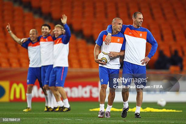Andre Ooijer and Johnny Heitinga of the Netherlands smile as team mates Arjen Robben, Mark Van Bommel and Dirk Kuyt celebrate during a Netherlands...
