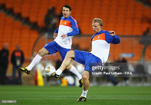 Dirk Kuyt of the Netherlands shoots at goal watched by Mark Van Bommel during a Netherlands training session, ahead of the 2010 FIFA World Cup Final,...