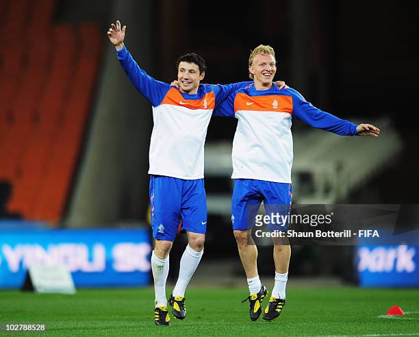 Mark Van Bommel and Dirk Kuyt of the Netherlands celebrate during a Netherlands training session, ahead of the 2010 FIFA World Cup Final, at Soccer...