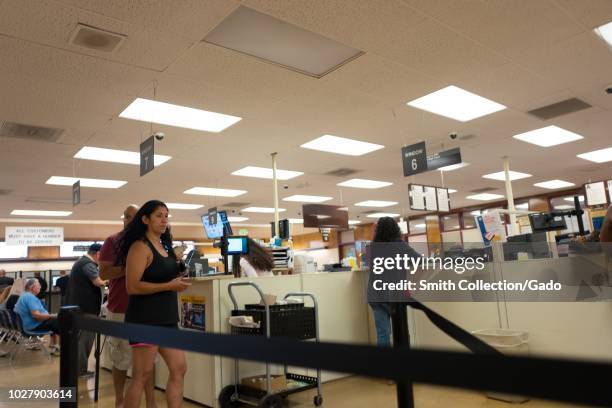 People wait in line at the California Department of Motor Vehicles office in Plesanton, California, August 28, 2018.