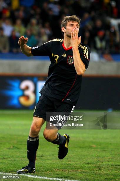 Thomas Mueller of Germany celebrates scoring the opening goal during the 2010 FIFA World Cup South Africa Third Place Play-off match between Uruguay...