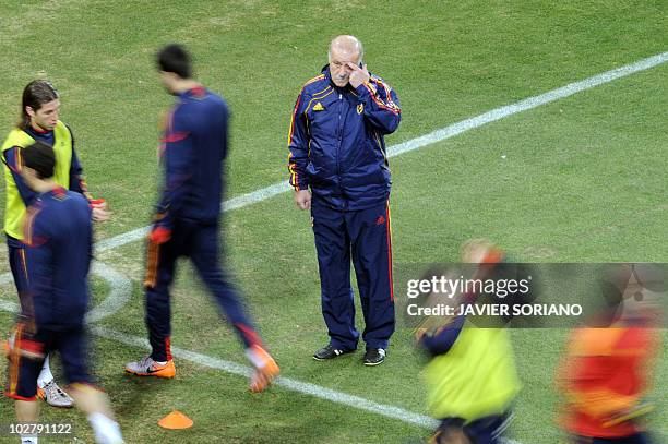 Spain's coach Vicente Del Bosque looks at his players during an official training session at Soccer City stadium in Soweto, suburban Johannesburg on...