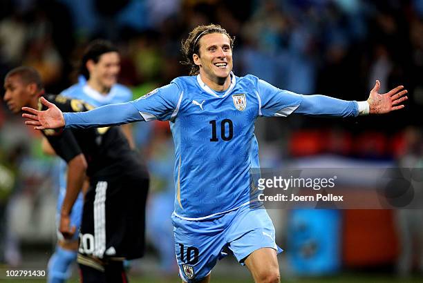 Diego Forlan of Uruguay celebrates scoring his team's second goal during the 2010 FIFA World Cup South Africa Third Place Play-off match between...