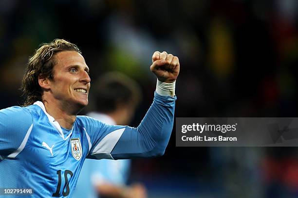 Diego Forlan of Uruguay celebrates scoring his team's second goal during the 2010 FIFA World Cup South Africa Third Place Play-off match between...