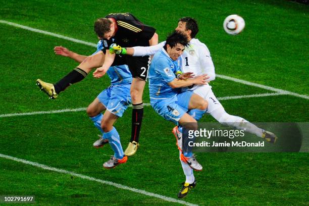 Marcell Jansen of Germany scores his team's second goal as Fernando Muslera of Uruguay attempts to save during the 2010 FIFA World Cup South Africa...