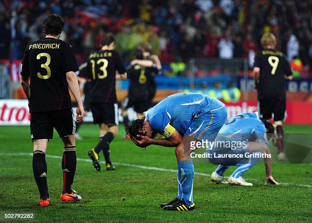 Diego Lugano of Uruguay reacts as Sami Khedira of Germany scores his team's third goal during the 2010 FIFA World Cup South Africa Third Place...