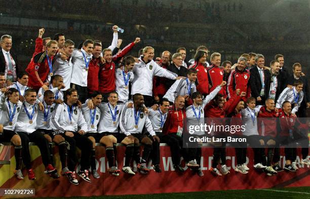 The Germany team celebrate victory and third place following the 2010 FIFA World Cup South Africa Third Place Play-off match between Uruguay and...