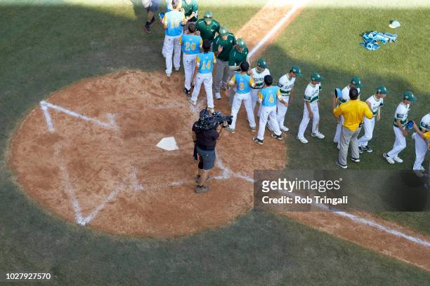 Little League World Series Championship: Asia-Pacific team members shaking hands after losing to United States West during Championship game at...