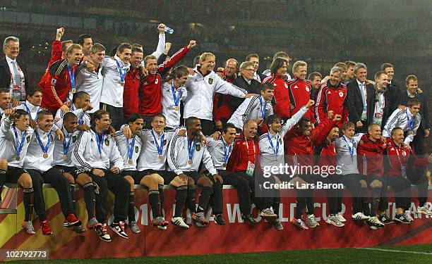 The Germany team celebrate victory and third place following the 2010 FIFA World Cup South Africa Third Place Play-off match between Uruguay and...