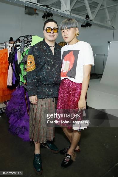 Designers Laurence Li and Chico Wang pose backstage before the... News ...