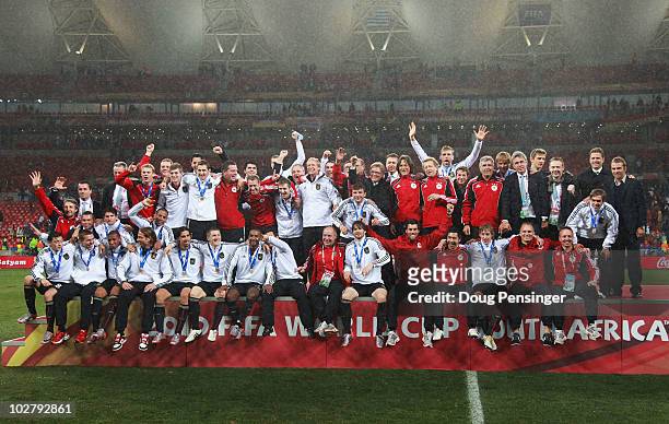 The Germany team celebrate victory and third place following the 2010 FIFA World Cup South Africa Third Place Play-off match between Uruguay and...