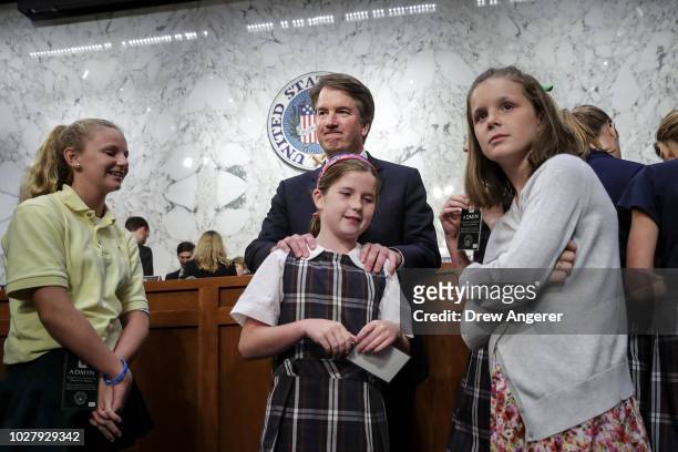 Supreme Court nominee Judge Brett Kavanaugh embraces his daughter Liza as he mingles with former players of the youth basketball team he coached...