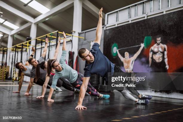 side plank exercises in gym - side plank pose stock pictures, royalty-free photos & images