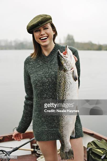 Model/actress Kate Groombridge fishing in Stanborough Lake, Welwyn Garden City, Hertfordshire, England.