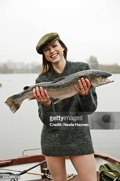 Model/actress Kate Groombridge fishing in Stanborough Lake, Welwyn Garden City, Hertfordshire, England.